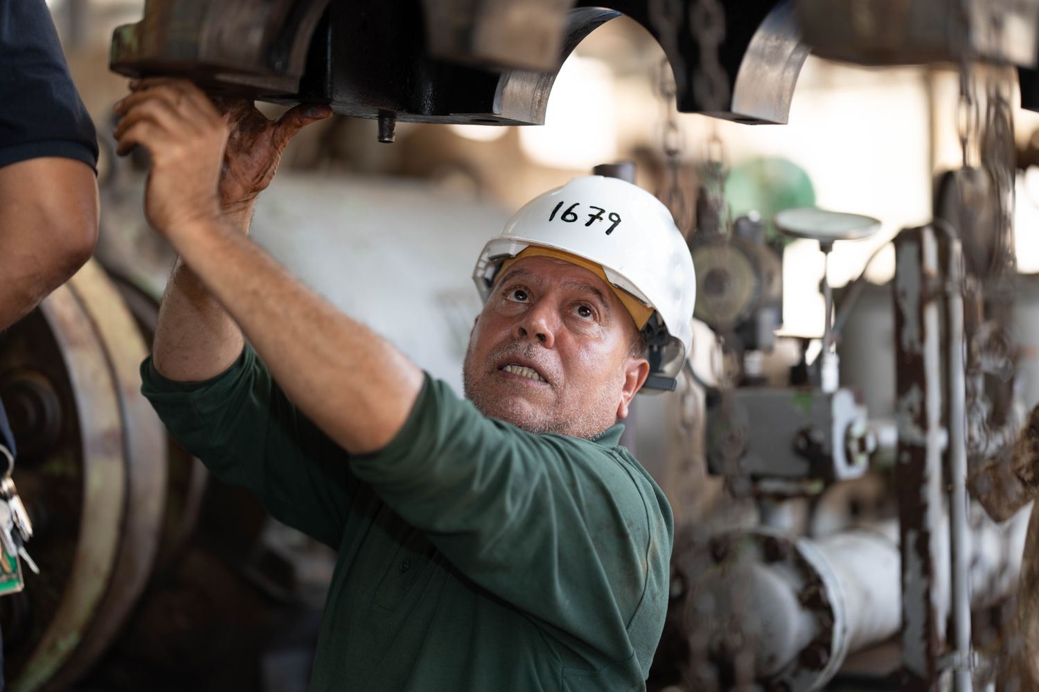 engineer inspecting machinery in industrial setting