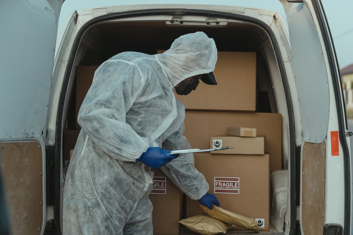 person checking parcels inside a delivery van