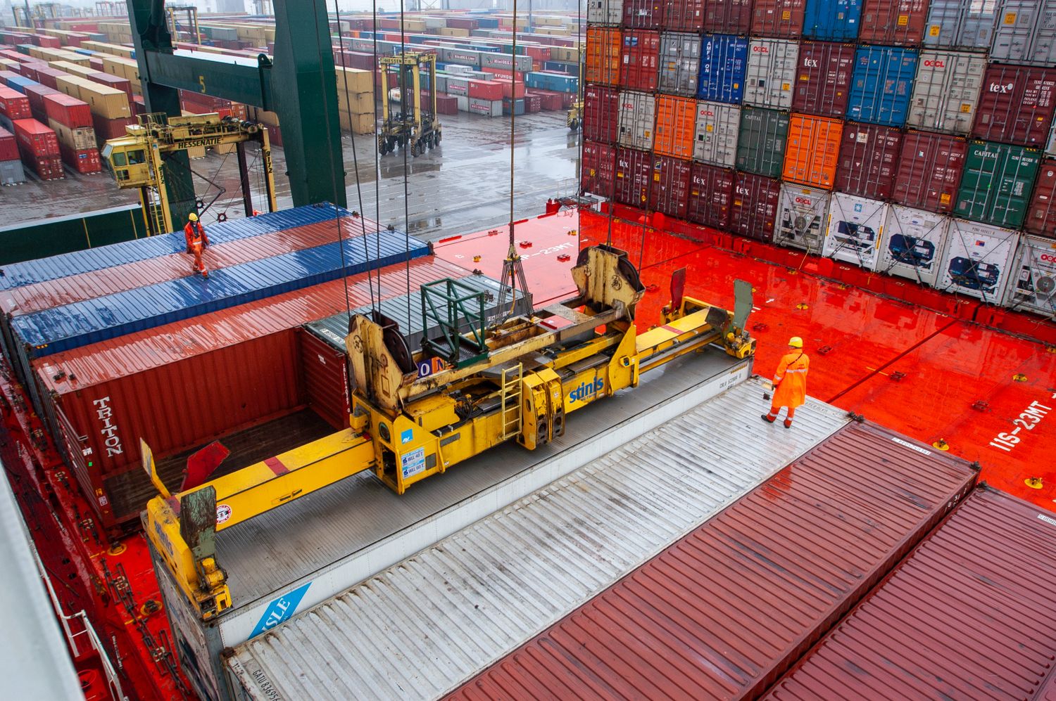 crane in action loading containers at the port