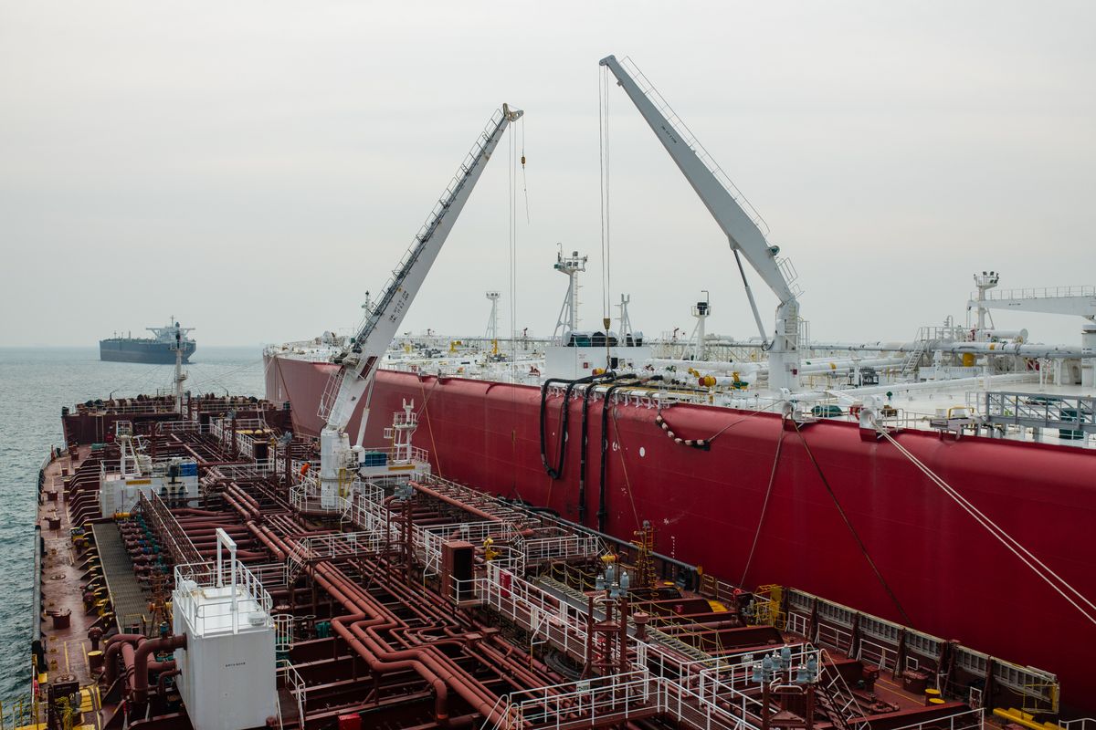 Large commercial tanker with deck cranes